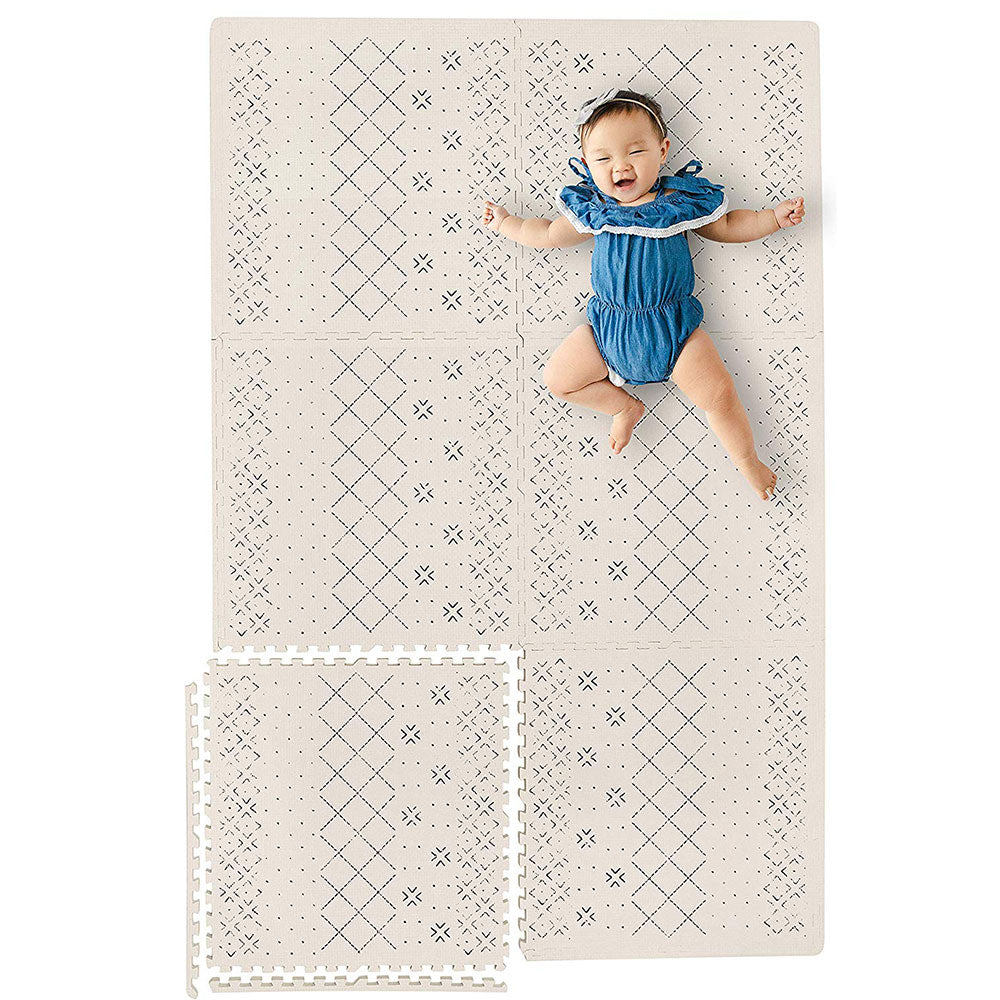 Infant Laying on a Carter Mudcloth Tan Neutral Baby Play Mat
