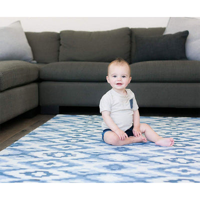 Toddler Sitting on Jackson Rug Blue Play Mat in Living Room