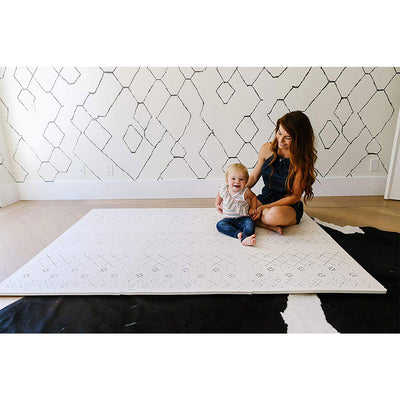 Woman and Baby Sitting on a Carter Mudcloth Tan Neutral Foam Playmat