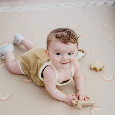 Infant Laying on Emery Rainbow Baby Foam Mat