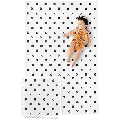 Infant Laying on Brooklyn Cross Black and White Foam Mats
